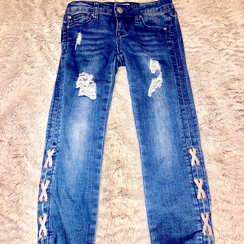Girls Hudson distressed jeans with cris cross detail.